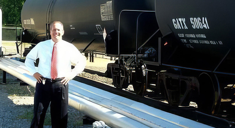 Smiling Man Infront Industrial Train